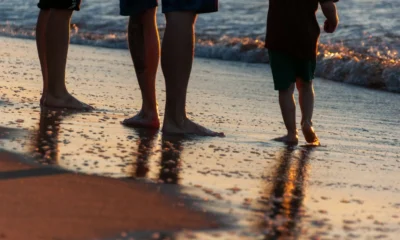 Familia en la playa durante una semana de vacaciones en Italia, ilustrando settimana mare Italia famiglia costo
