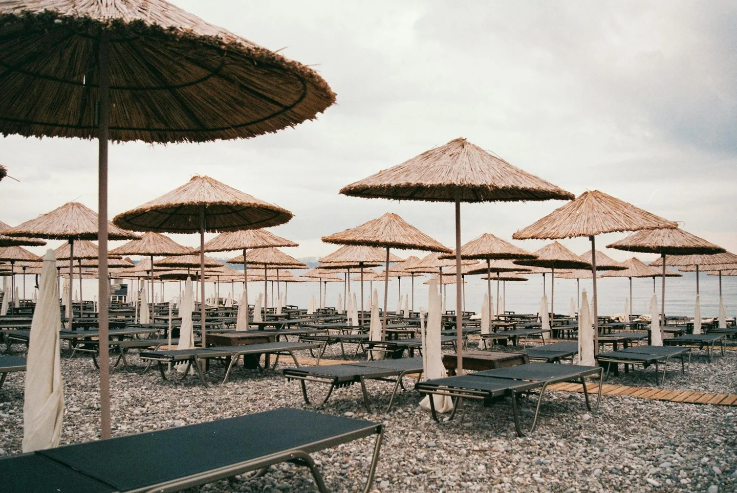 Foto de beach umbrella sunbeds para ilustrar quanto costa giornata al mare en una playa con servicios de pago.
