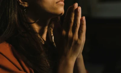 Persona rezando con luz suave para ilustrar quali sono i doni dello spirito santo en un contexto de reflexión espiritual.