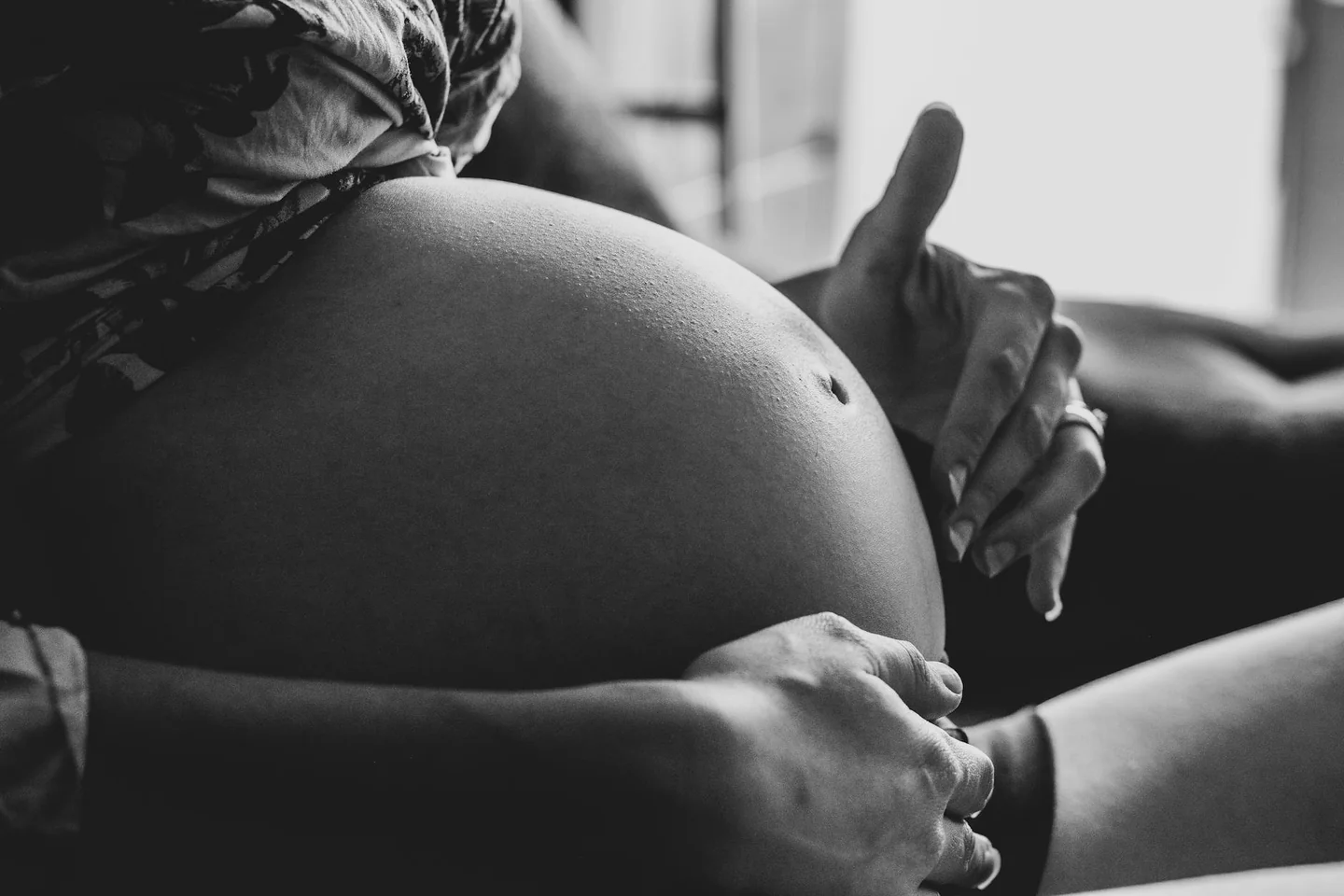 Fotografía de una mujer embarazada tocándose la barriga, útil para ilustrar «cosa si sente quando il feto si gira» y los cambios de posición del bebé durante el embarazo.