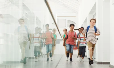 Un estudiante corriendo por el pasillo de la escuela para ilustrar "cosa succede se si arriva tardi alla maturità"